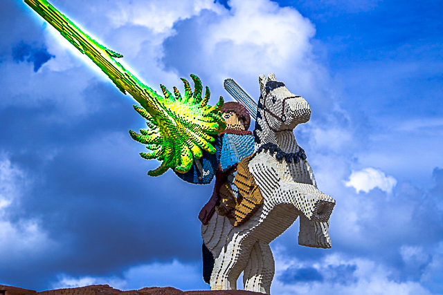 LEGO knight on horseback wielding a lightning lance against a stormy sky
