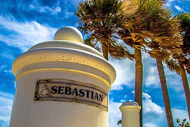 Sebastian Street marker in Fort Lauderdale, palm trees bending in the breeze