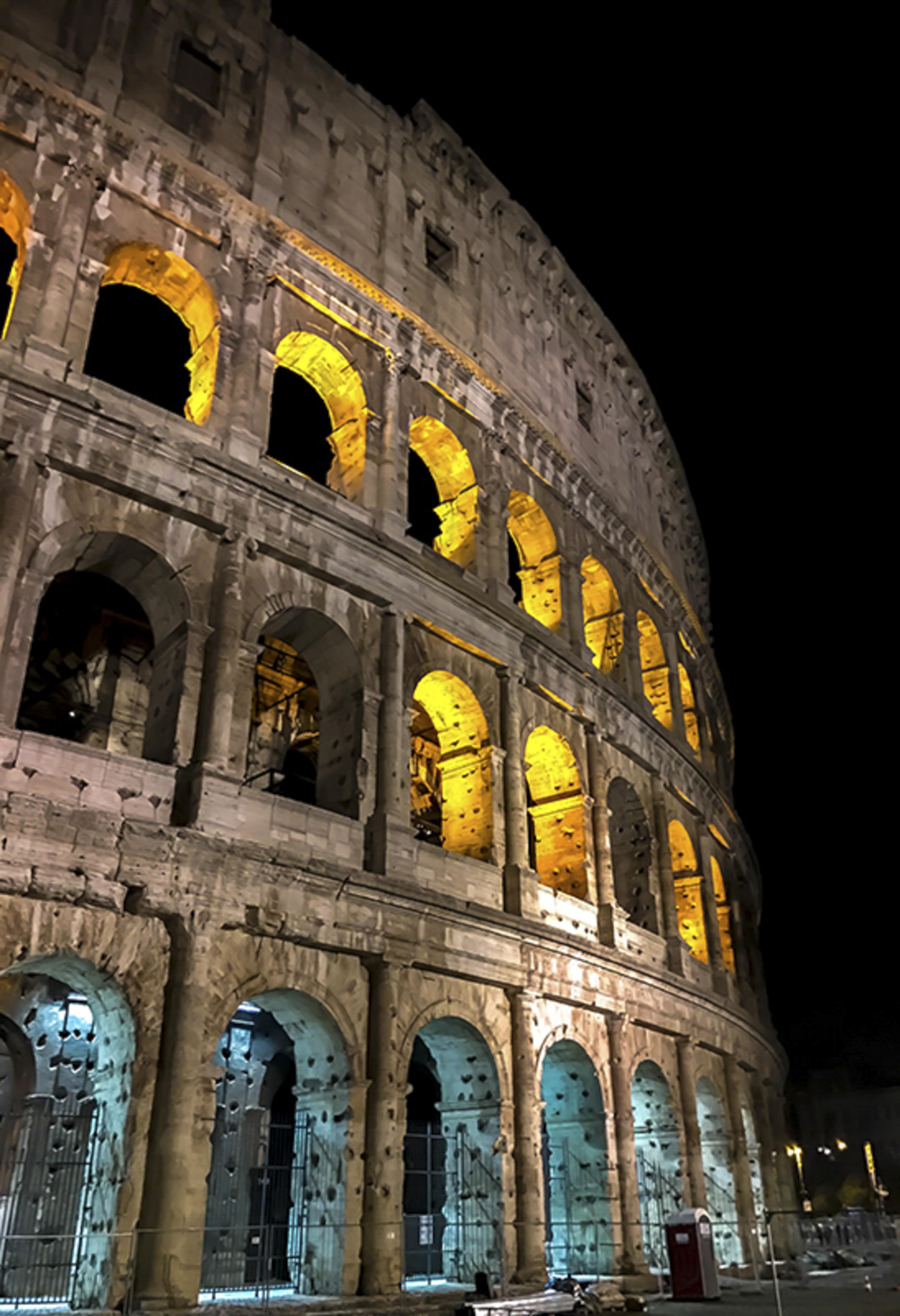Colosseum illuminated at night, full exterior view