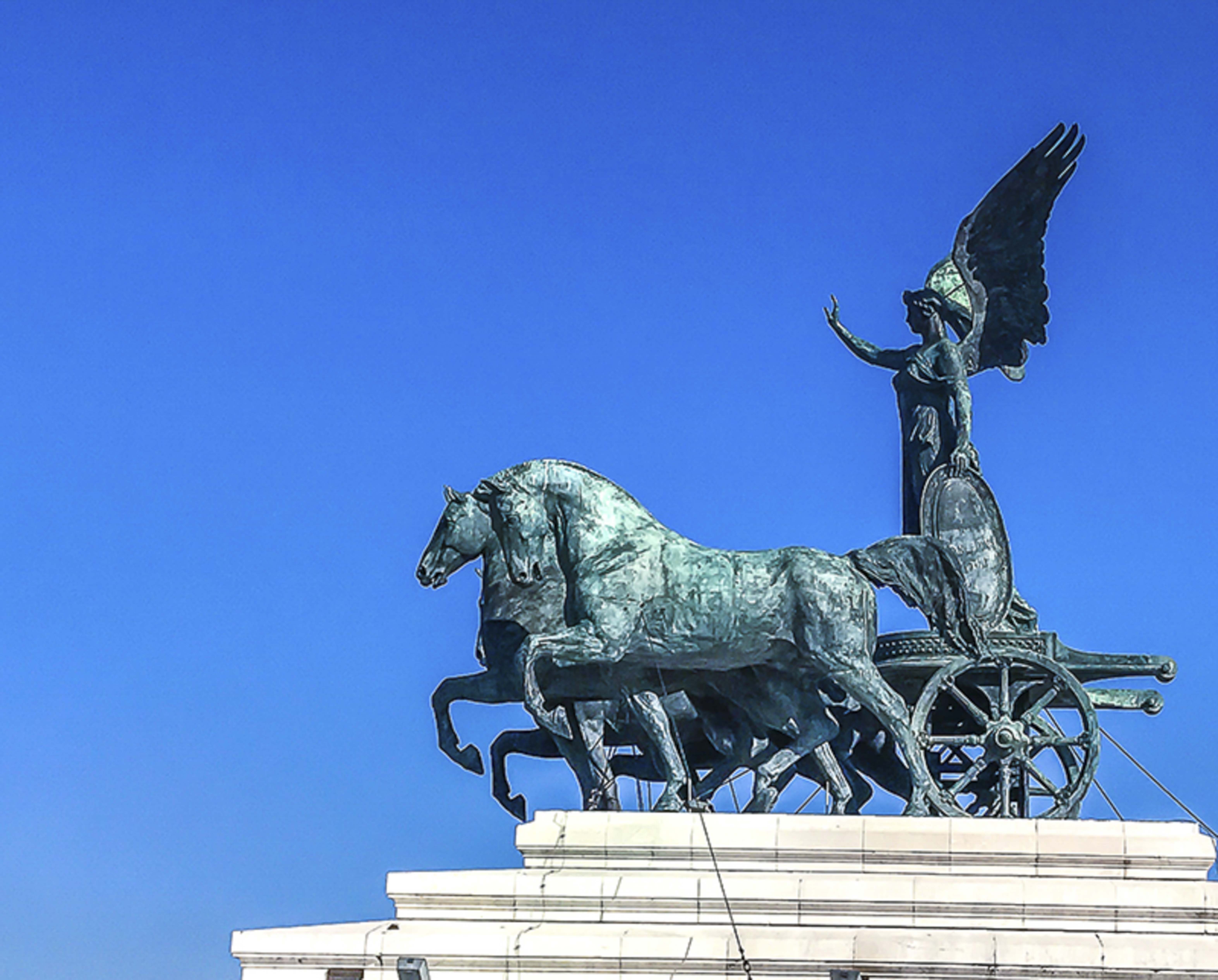 Quadriga of Unity — bronze winged victory chariot atop the Vittoriano against blue sky