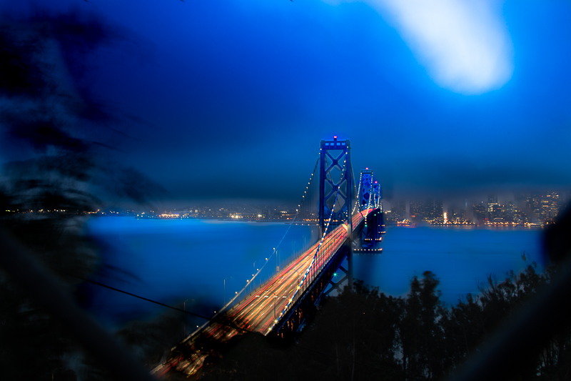 Bay Bridge lit in blue — long exposure from the Embarcadero waterfront