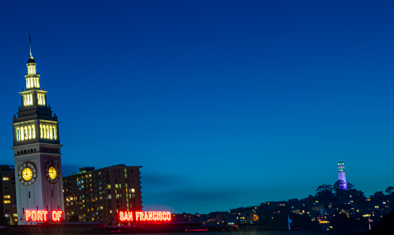 Bay Bridge at dusk — lights beginning to illuminate the suspension towers