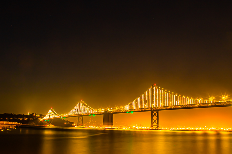 Pier 14 long exposure — fog rolling in past the bridge