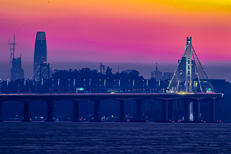 Boat rigging silhouetted against a deep orange sunset, Emeryville