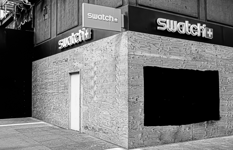 Closed business signs in the window — a city on pause