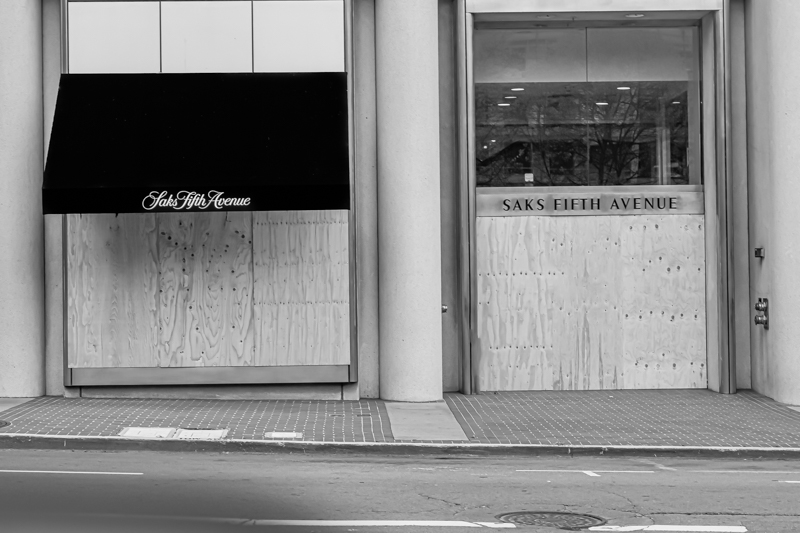 Union Square with barriers up and stores dark — heart of SF commerce, closed