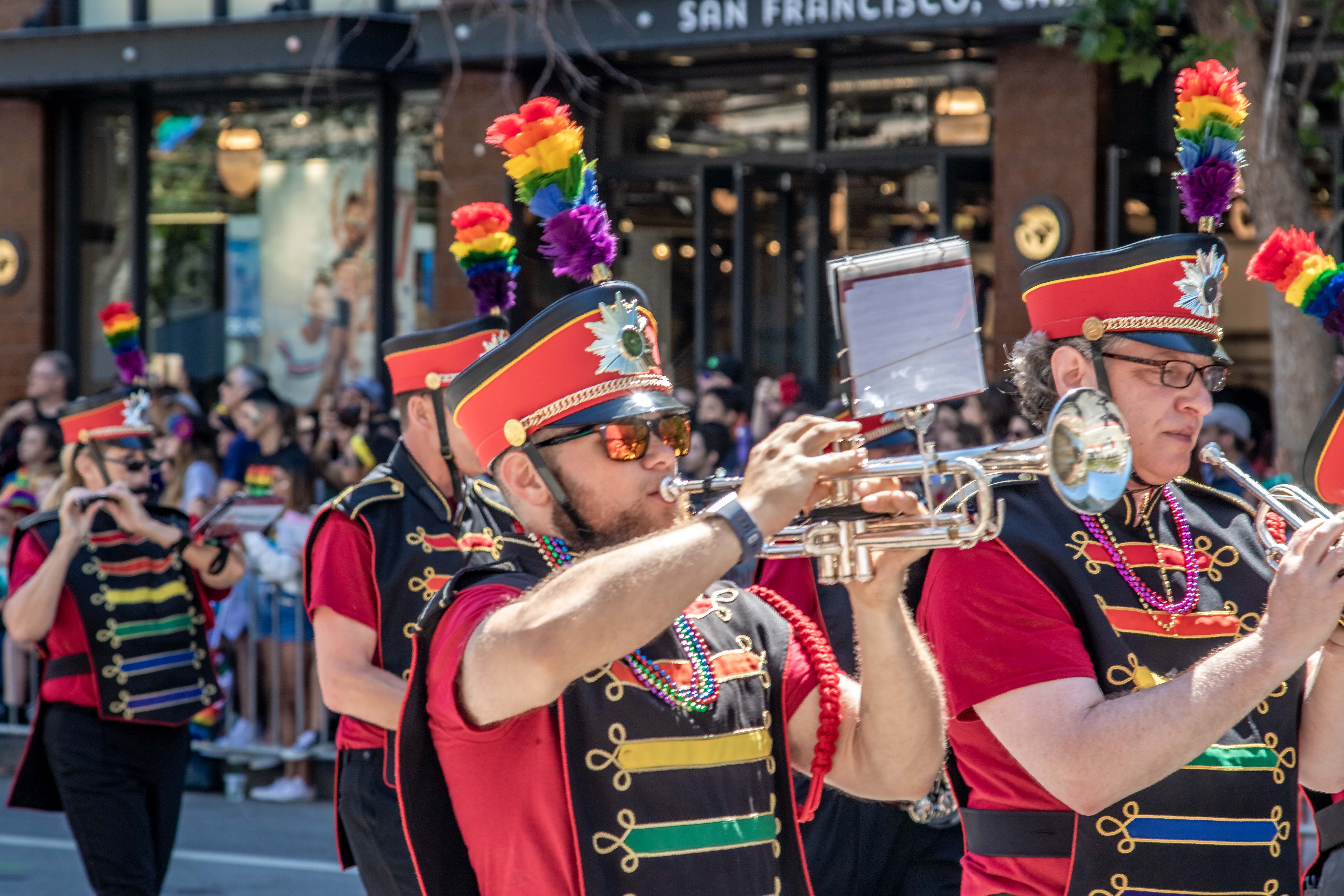 Freedom Band member playing tenor saxophone, pride colors on display
