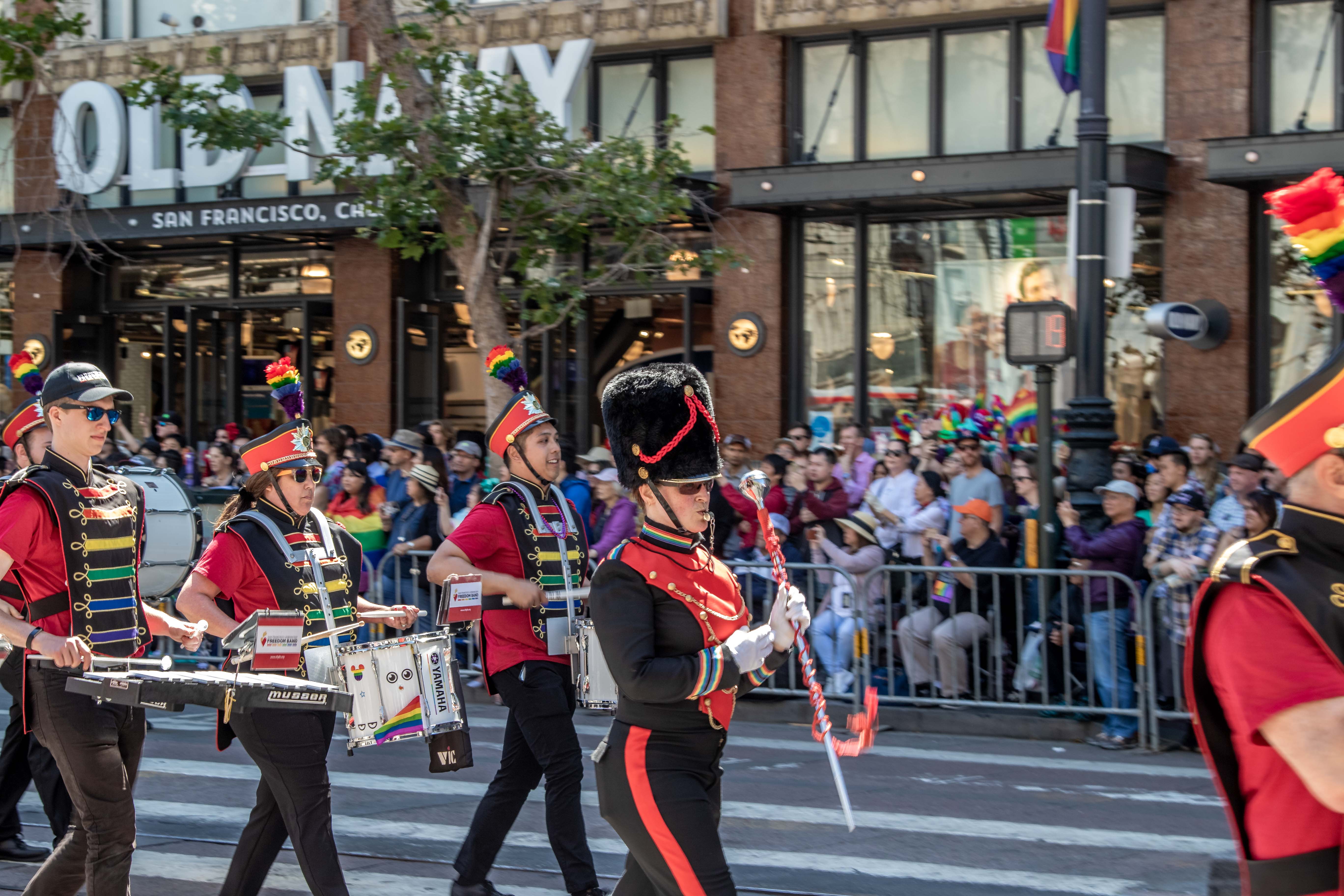 Freedom Band brass player — sunglasses and rainbow plume