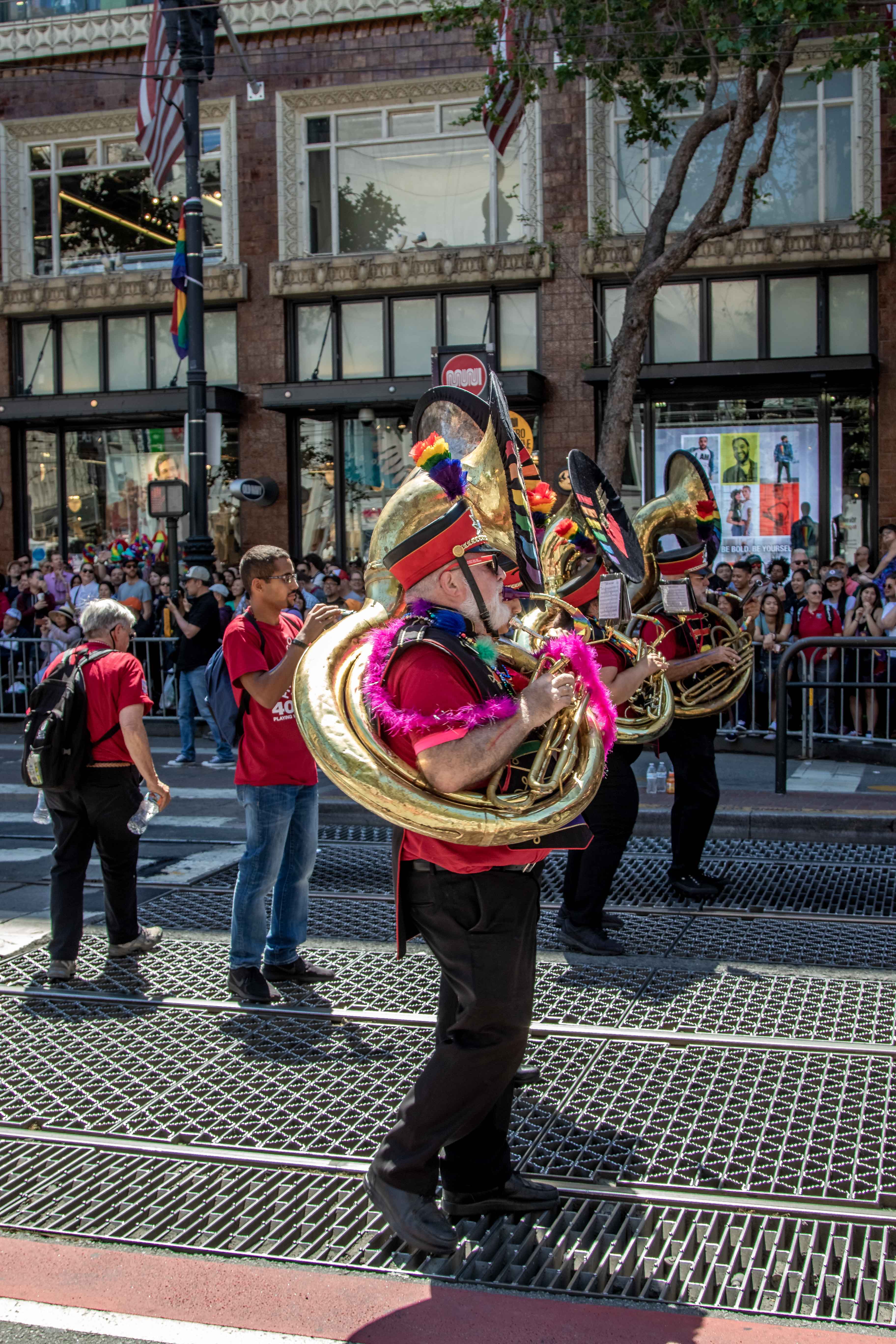 SF Pride — musicians in formation, rainbow flags in background