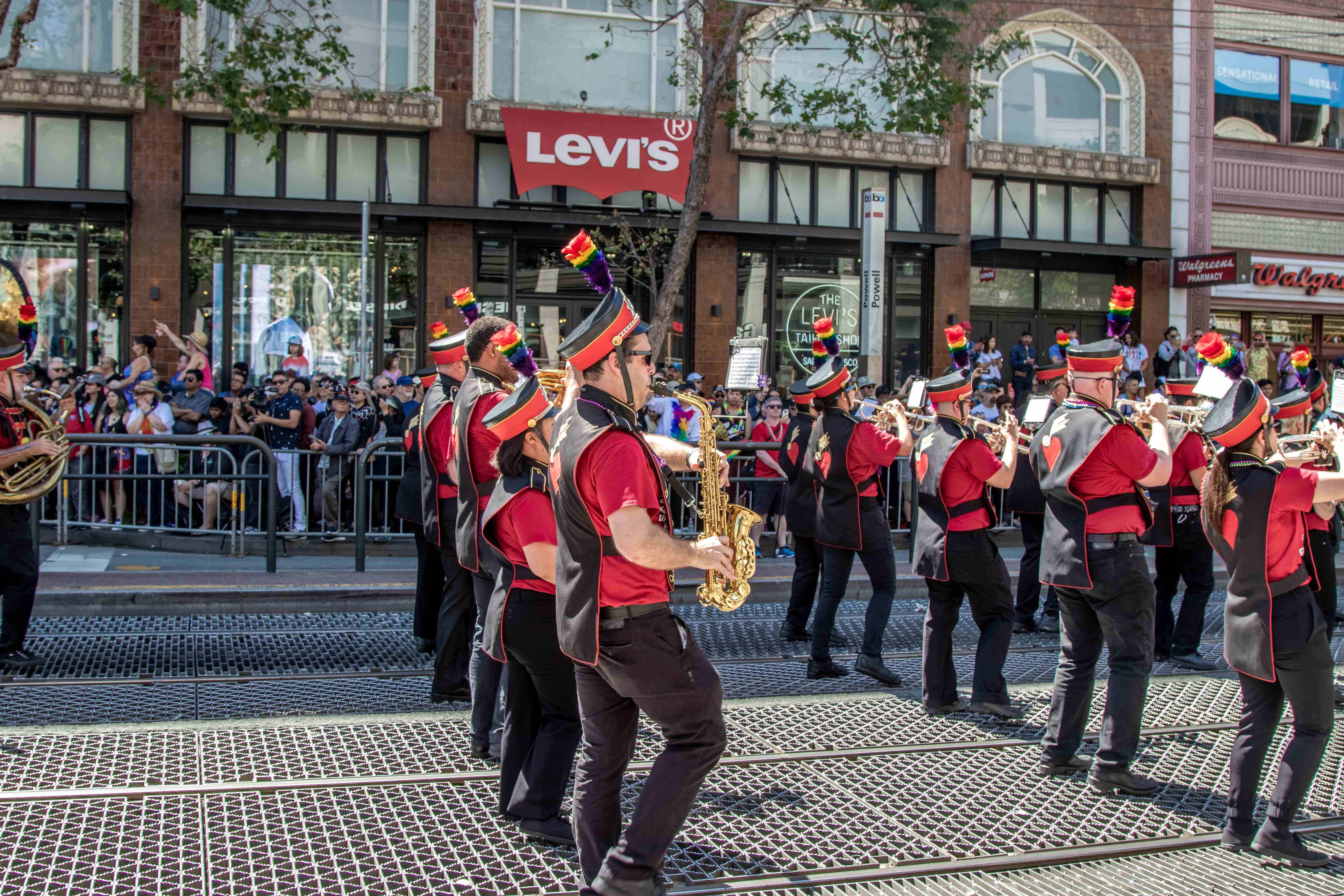 Freedom Band trombonist mid-slide, red uniform gleaming