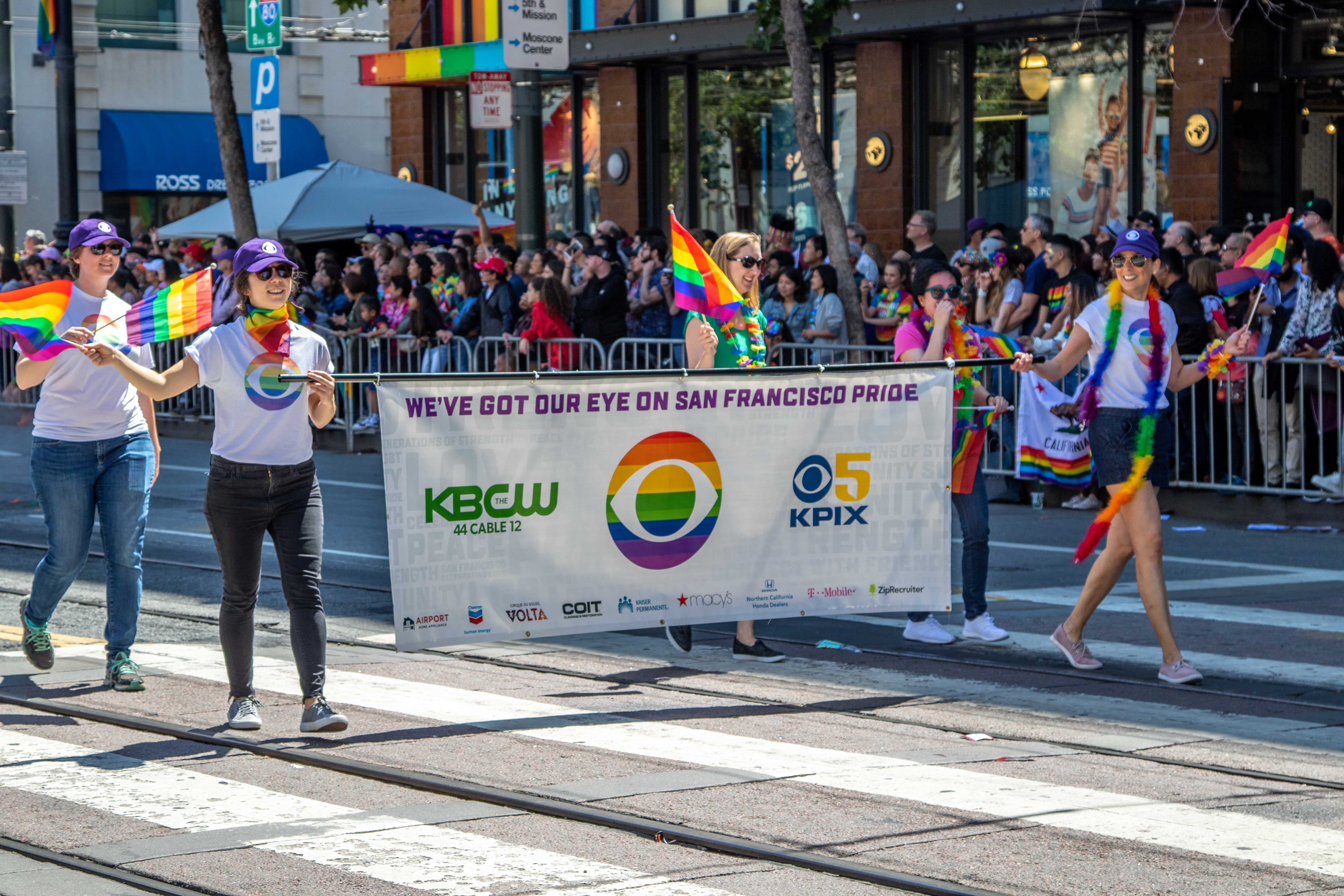 Freedom Band marching — rainbow plumes bobbing in the sunlight