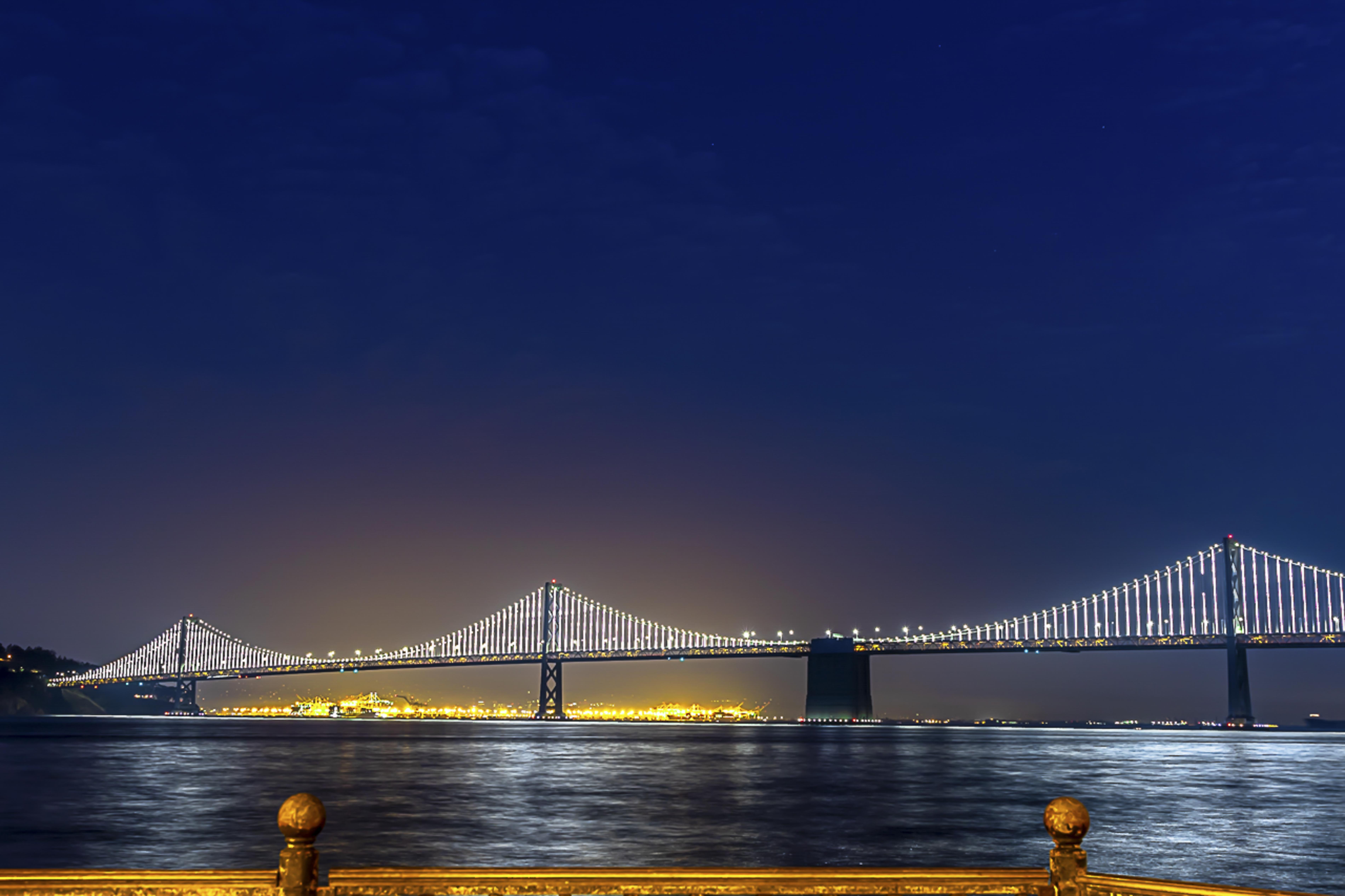 Bay Bridge lit up at night from the Embarcadero