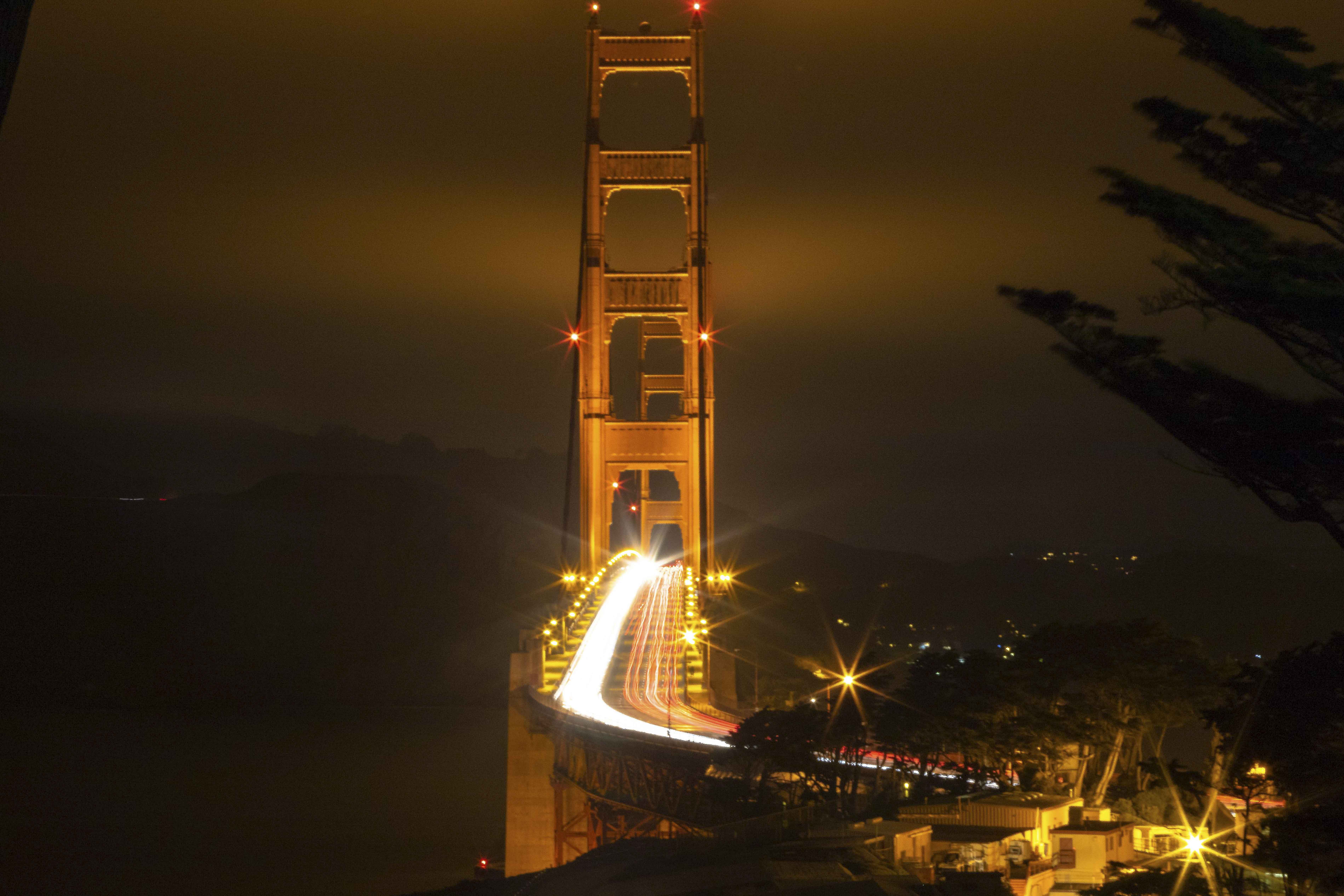 Golden Gate Bridge north tower with light trails from traffic at night