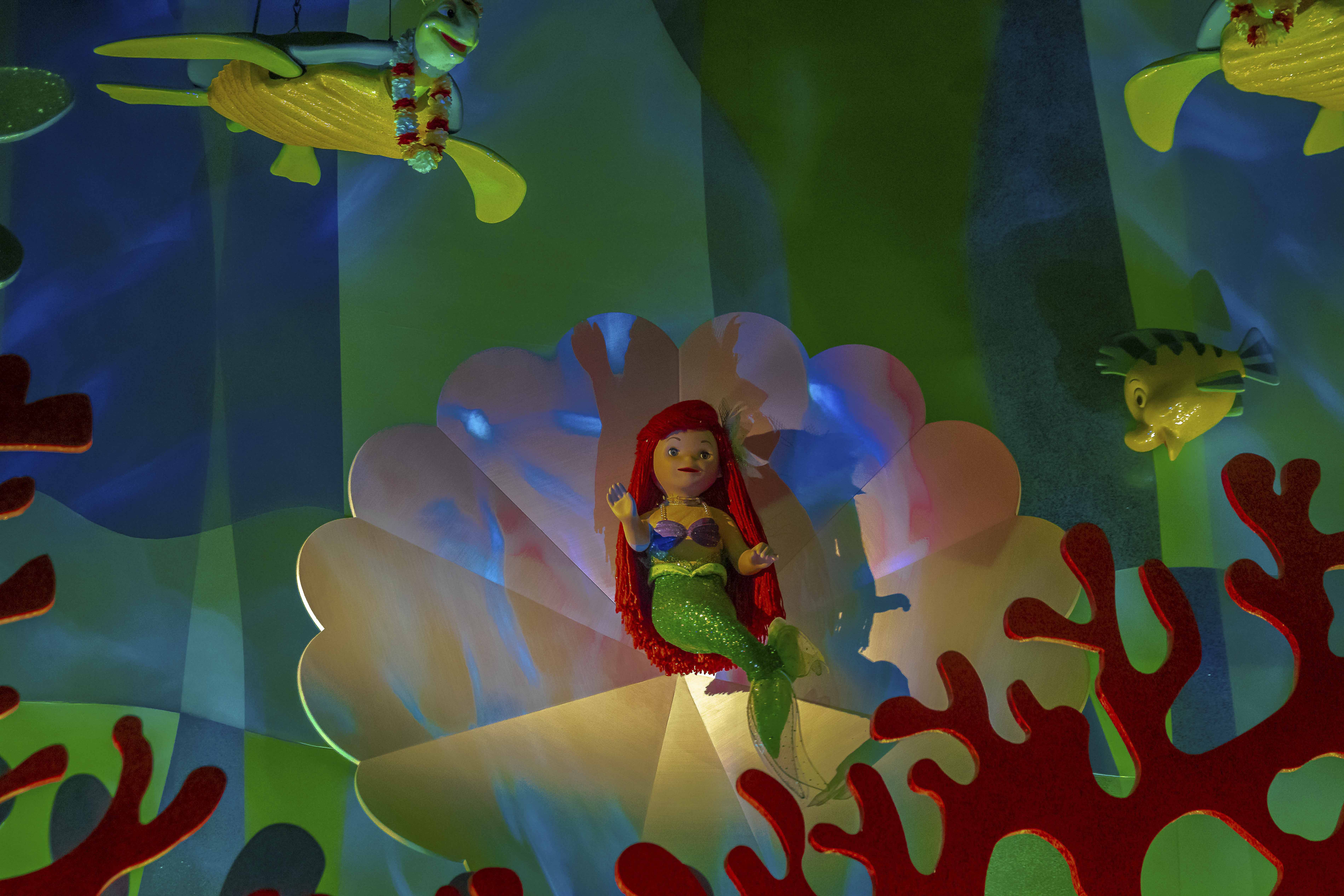 It's a Small World — Ariel seated on a clamshell in her undersea grotto
