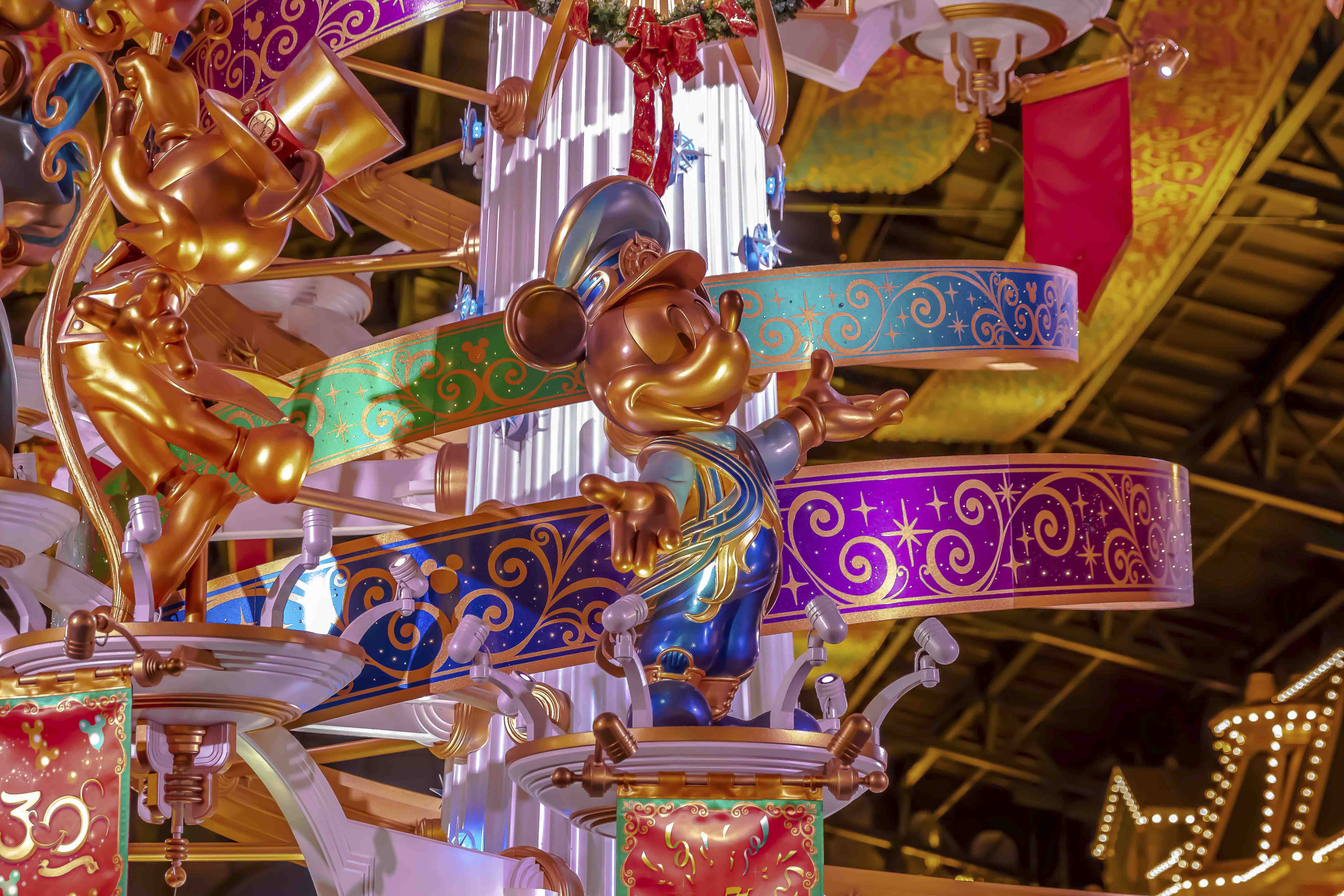 Grand Court chandelier with a golden Mickey figure — Tokyo Disneyland