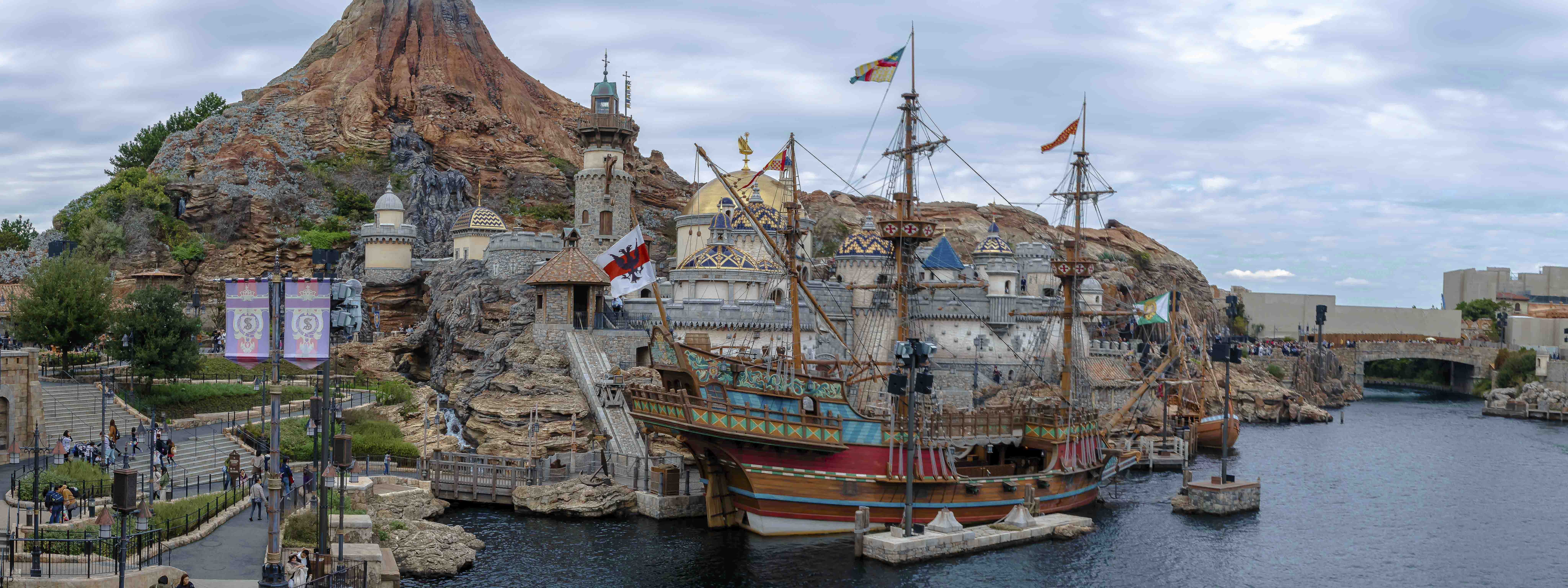 Mediterranean Harbor panorama — pirate ship docked beneath the fortress walls