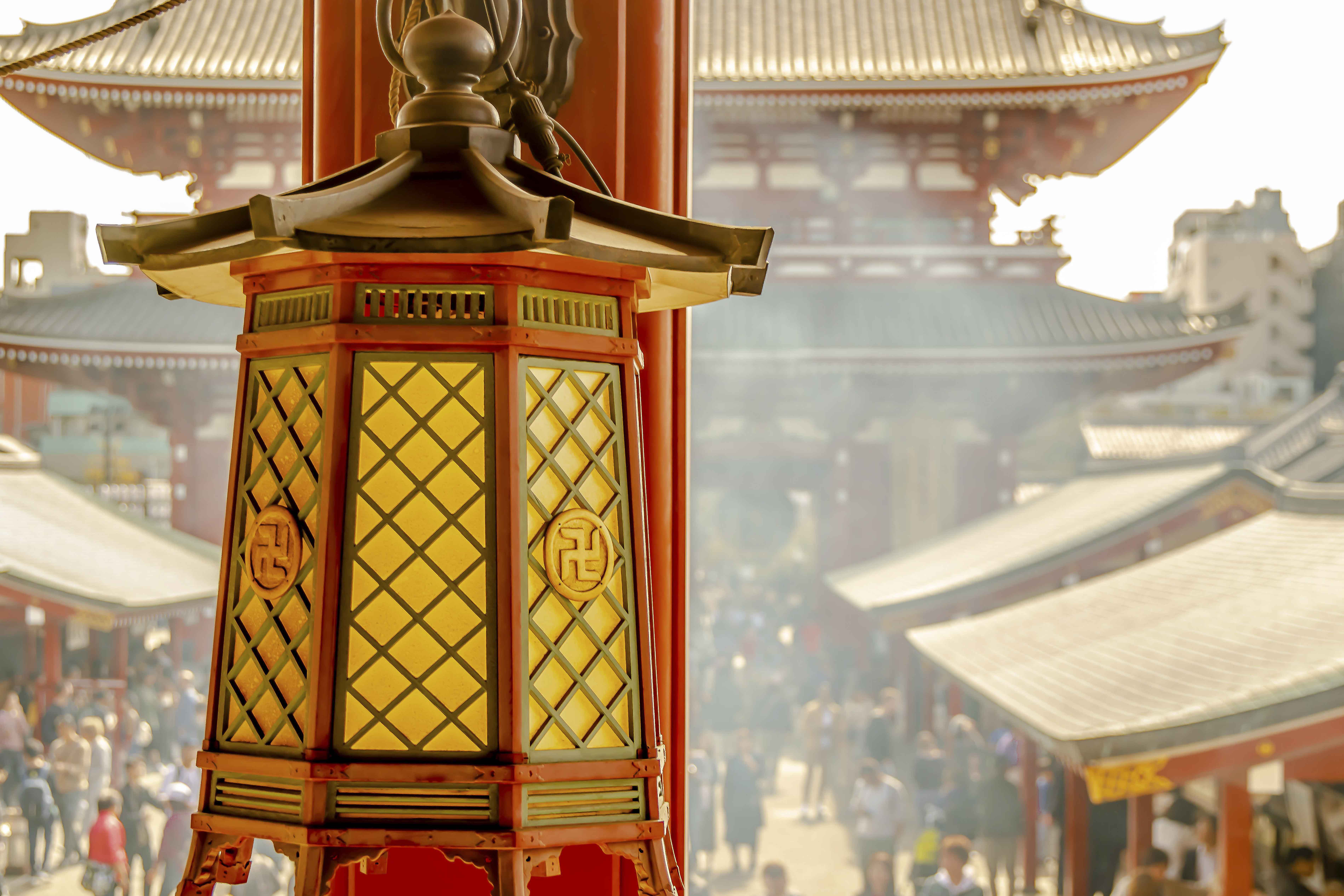 Temple lantern with Senso-ji courtyard and smoke beyond