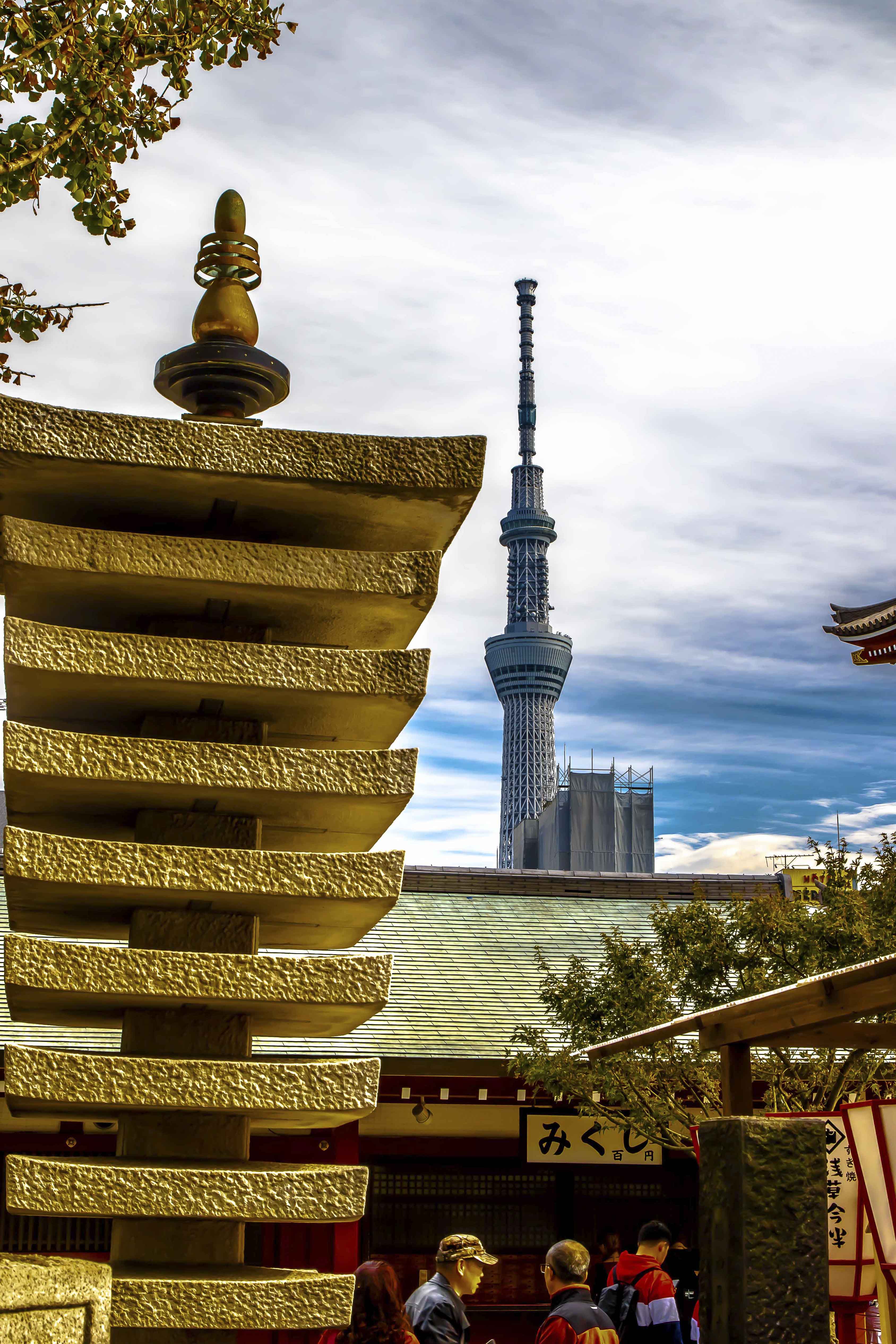 Stone pagoda with Tokyo Skytree rising behind