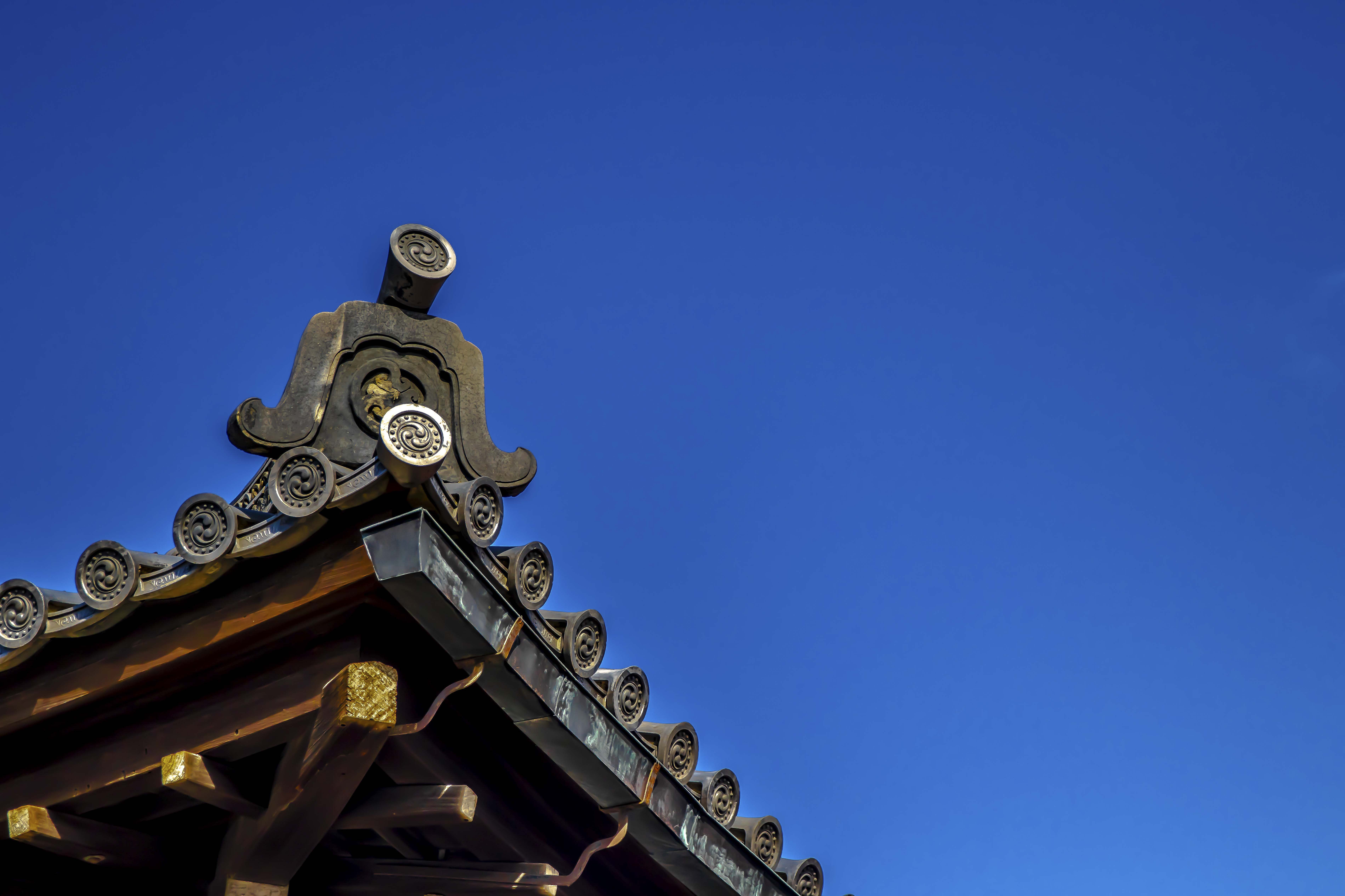 Traditional curved eave against deep blue sky