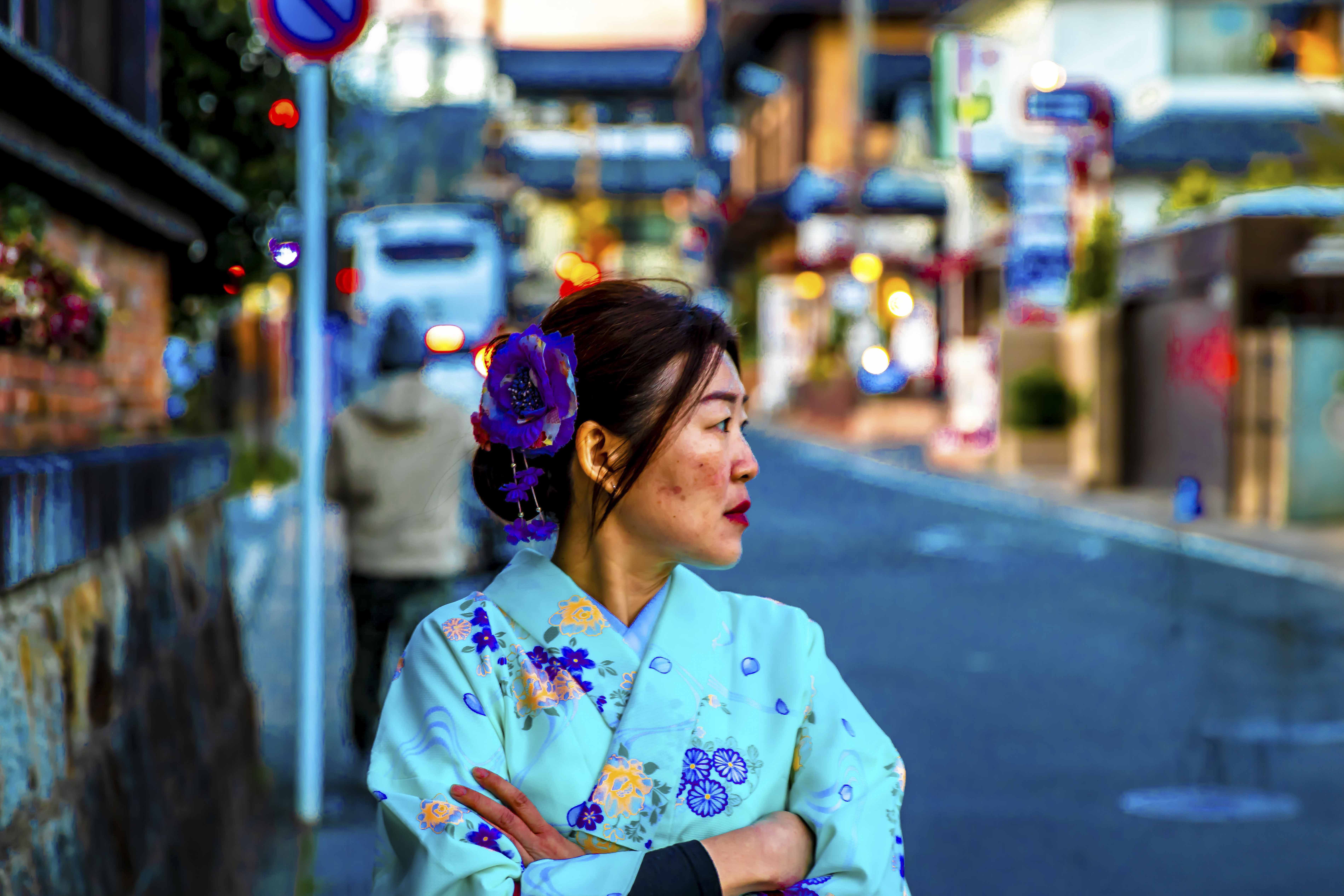 Woman in kimono on a Kyoto street at dusk